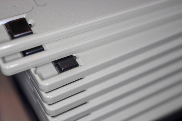 Stacked light-colored license plate frames featuring black attachment clips.