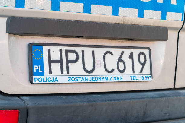Polish police vehicle displays HPU C619 license plate frames with recruitment ad.